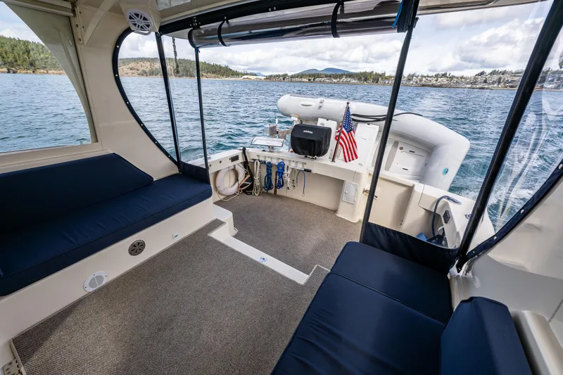 Misty Yacht Photos Pics 2007 Mainship Pilot 34 boat interior with seating, overlooking scenic water and shoreline.