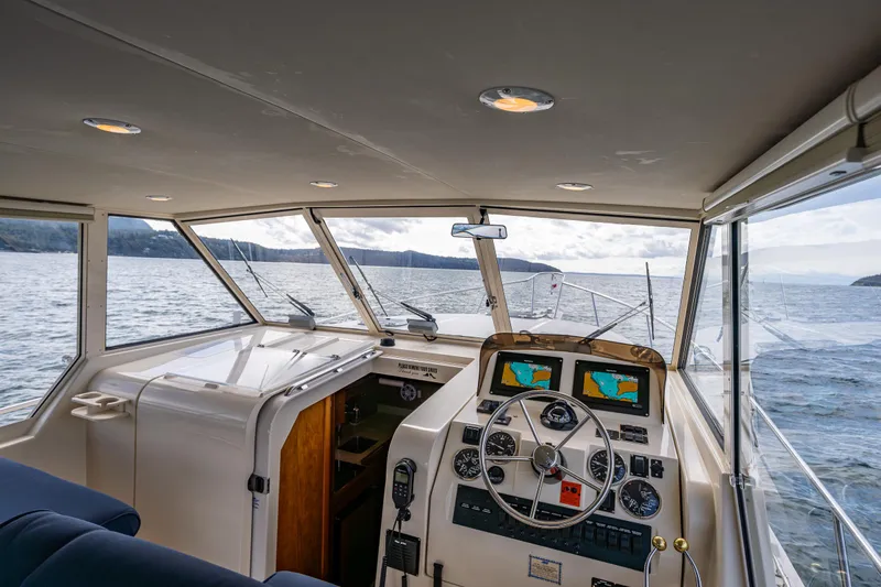 Misty Yacht Photos Pics 2007 Mainship Pilot 34 boat interior with navigation equipment, steering wheel, and ocean view.