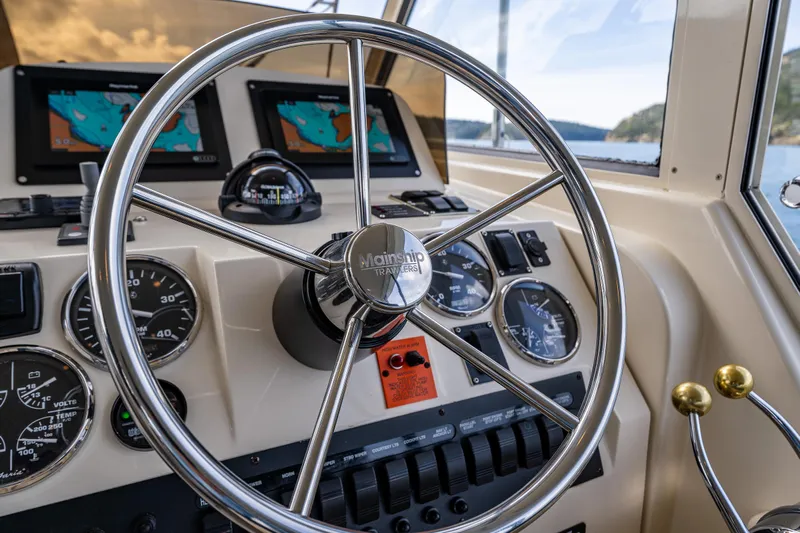 Misty Yacht Photos Pics 2007 Mainship Pilot 34 helm with steering wheel, gauges, and navigation screens.