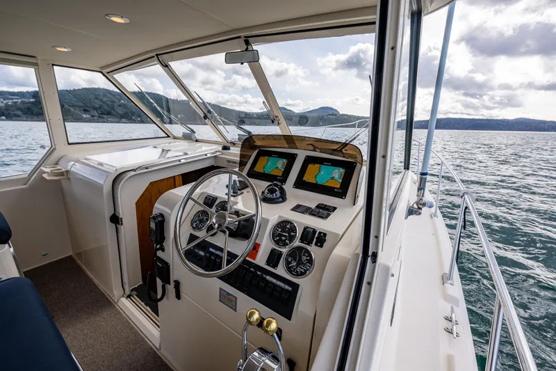 Misty Yacht Photos Pics 2007 Mainship Pilot 34 boat interior with navigation equipment and scenic water view.