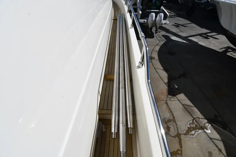 Surfin The Net Yacht Photos Pics Side deck view of 2001 Ferretti Yachts 72, featuring sleek railings and wooden flooring.