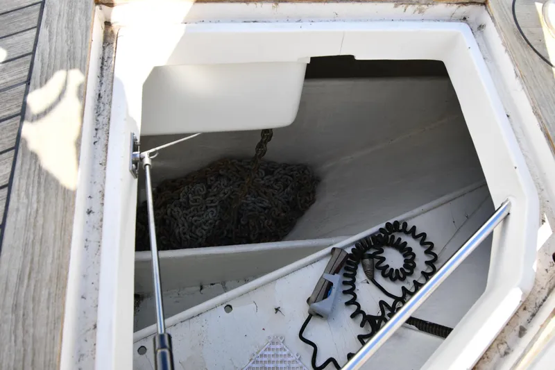 Surfin The Net Yacht Photos Pics Anchor chain compartment on a 2001 Ferretti Yachts 72, featuring coiled cable and equipment.