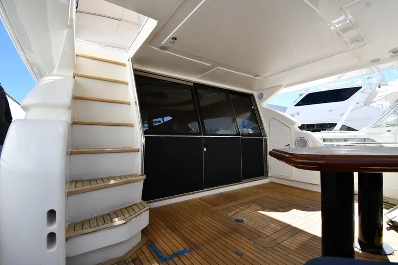 Surfin The Net Yacht Photos Pics 2001 Ferretti Yachts 72 aft deck with wooden flooring and staircase.