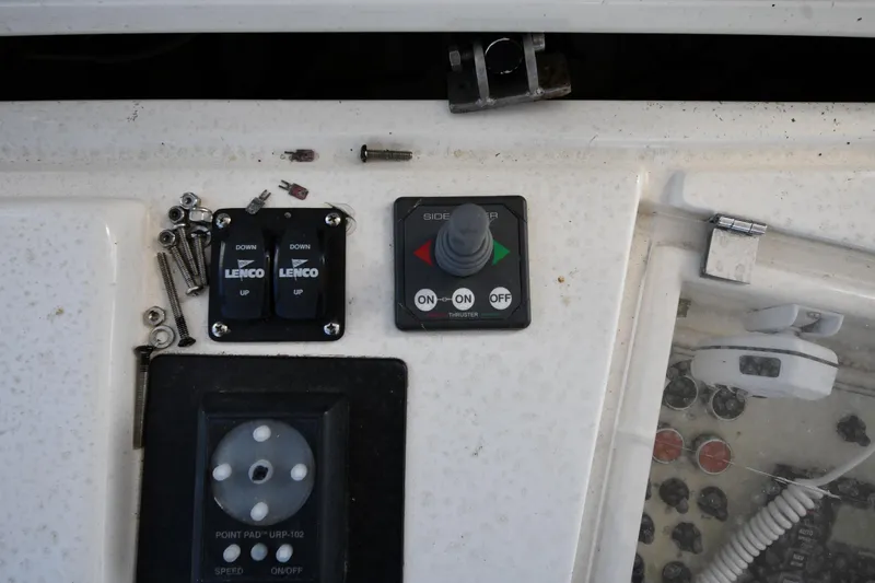 Surfin The Net Yacht Photos Pics Control panel of a 2001 Ferretti Yachts 72 with switches and screws.