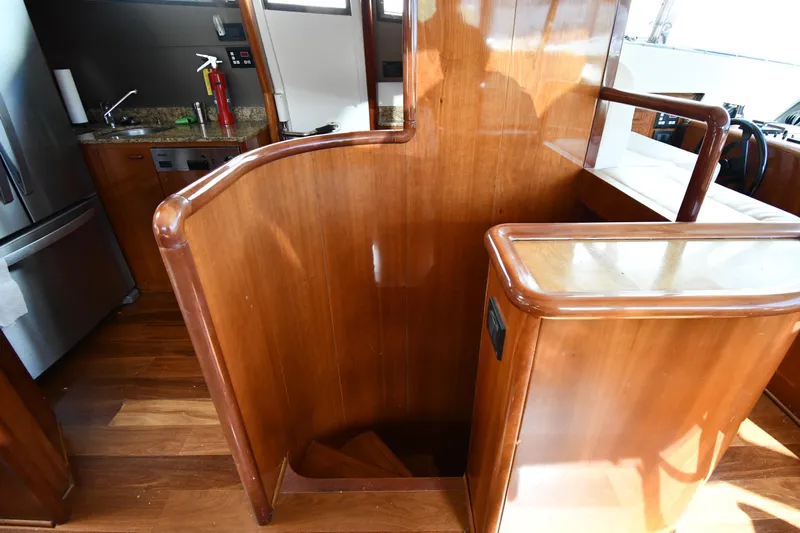 Surfin The Net Yacht Photos Pics Interior of 2001 Ferretti Yachts 72, featuring wooden staircase and modern kitchen area.