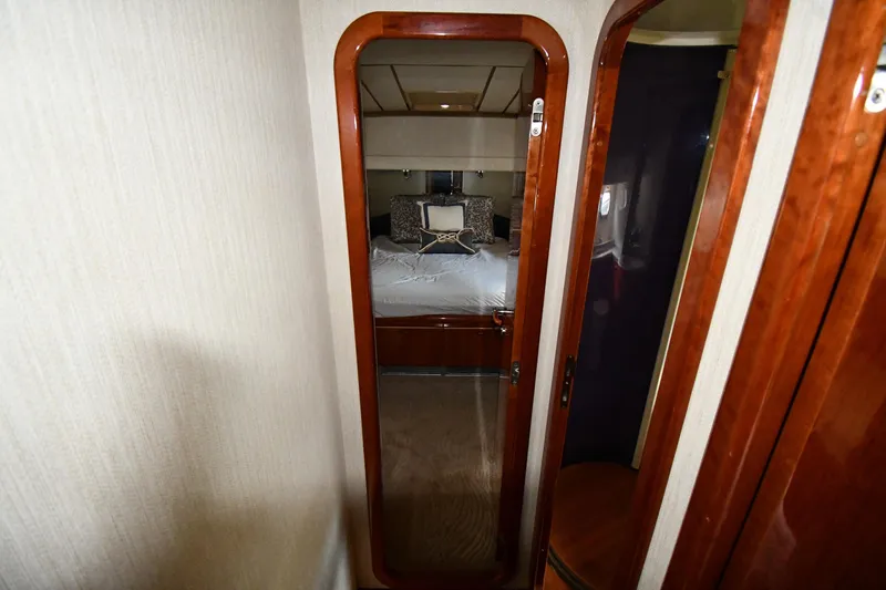 Surfin The Net Yacht Photos Pics Luxurious bedroom interior of 2001 Ferretti Yachts 72, featuring elegant wood finishes.