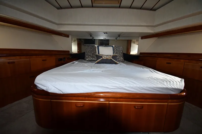 Surfin The Net Yacht Photos Pics Luxurious bedroom interior of 2001 Ferretti Yachts 72 with elegant wood finish.