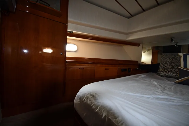 Surfin The Net Yacht Photos Pics Luxurious cabin interior of 2001 Ferretti Yachts 72 with wood finish and cozy bedding.