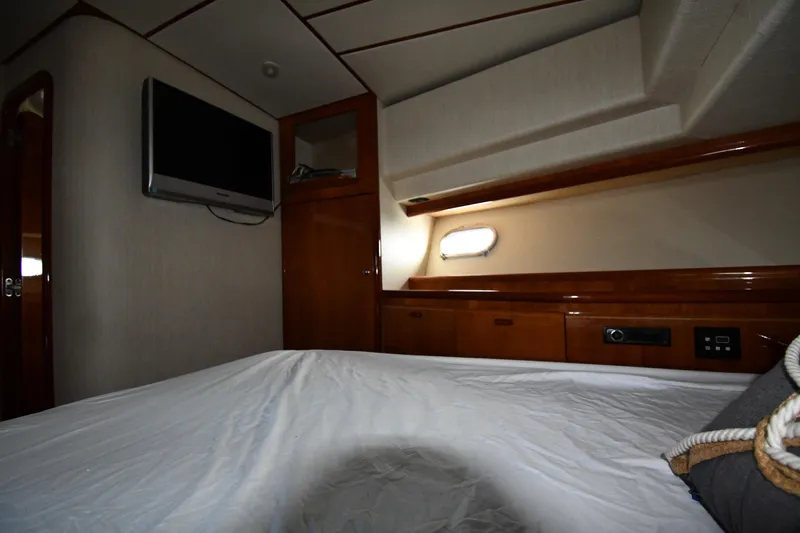 Surfin The Net Yacht Photos Pics Interior cabin of 2001 Ferretti Yachts 72, featuring wood paneling and a mounted TV.