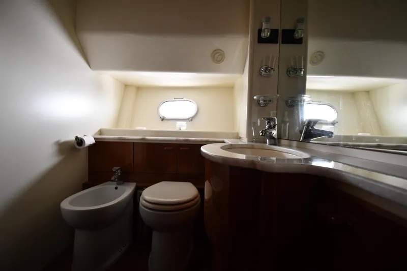 Surfin The Net Yacht Photos Pics Bathroom interior of 2001 Ferretti Yachts 72, featuring toilet, bidet, and sink.