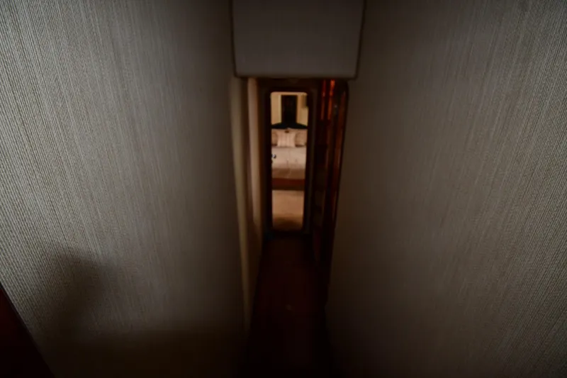 Surfin The Net Yacht Photos Pics Narrow hallway inside 2001 Ferretti Yachts 72, leading to a cozy cabin.