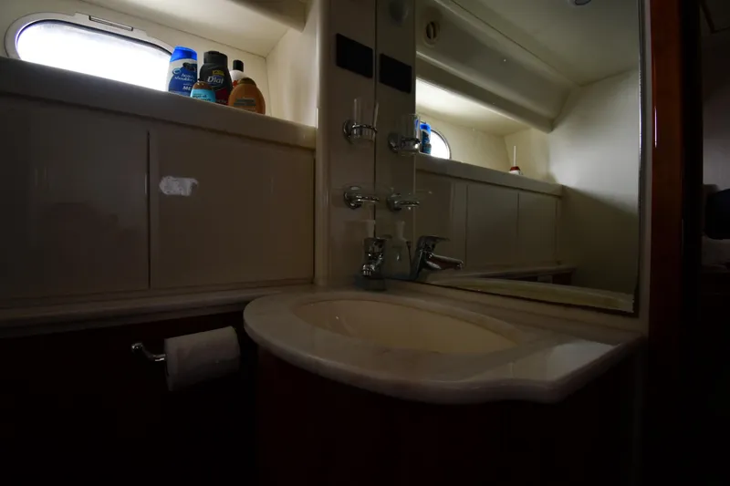 Surfin The Net Yacht Photos Pics Bathroom interior of 2001 Ferretti Yachts 72, featuring sink and toiletries.