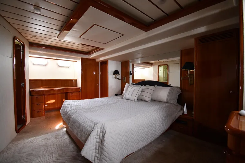 Surfin The Net Yacht Photos Pics Luxurious bedroom interior of 2001 Ferretti Yachts 72, featuring elegant wood finishes.