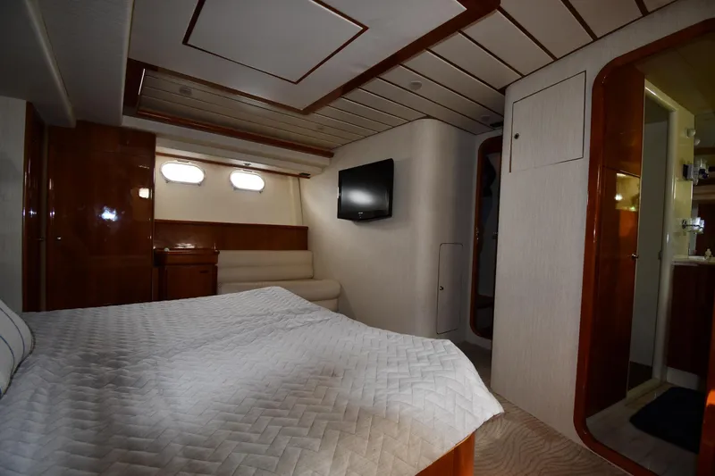 Surfin The Net Yacht Photos Pics Luxurious bedroom interior of 2001 Ferretti Yachts 72 with elegant wood finishes and modern amenities.