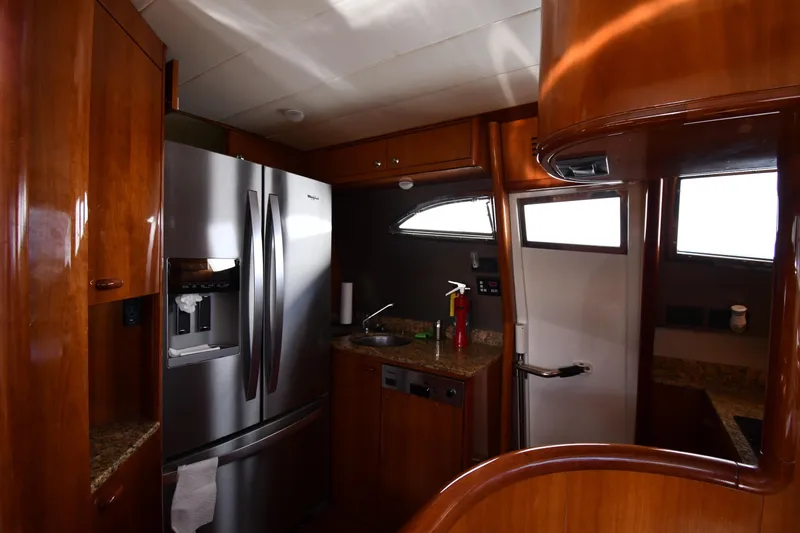Surfin The Net Yacht Photos Pics Luxurious kitchen interior of 2001 Ferretti Yachts 72 with stainless steel appliances.