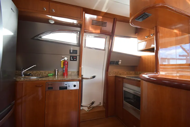 Surfin The Net Yacht Photos Pics Luxurious 2001 Ferretti Yachts 72 kitchen with wood cabinetry and modern appliances.