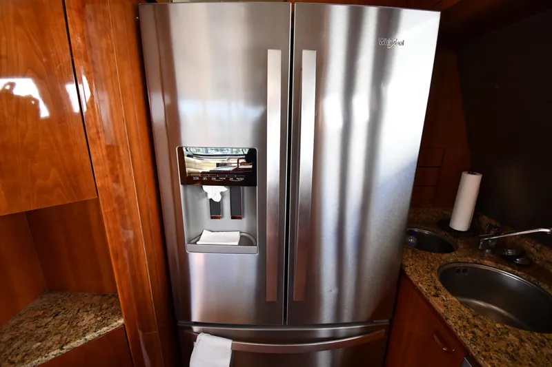 Surfin The Net Yacht Photos Pics Stainless steel refrigerator in 2001 Ferretti Yachts 72 kitchen with granite countertops.