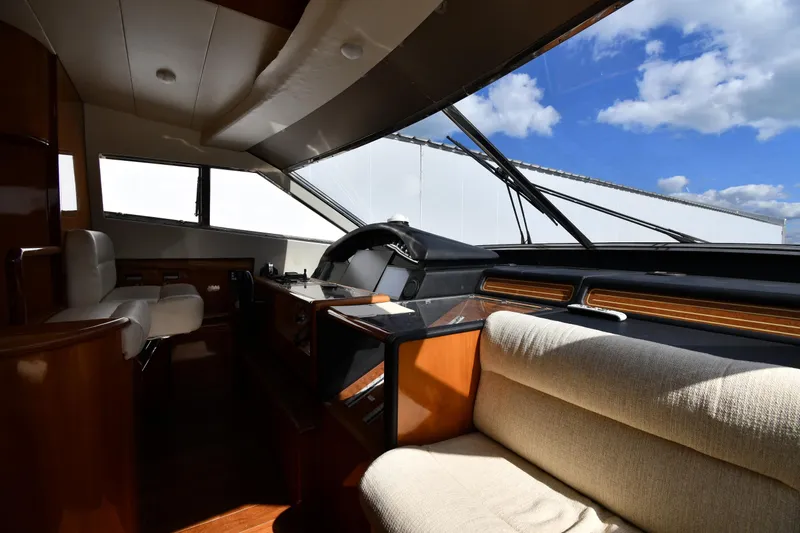 Surfin The Net Yacht Photos Pics Interior of 2001 Ferretti Yachts 72, featuring helm and seating under blue sky.