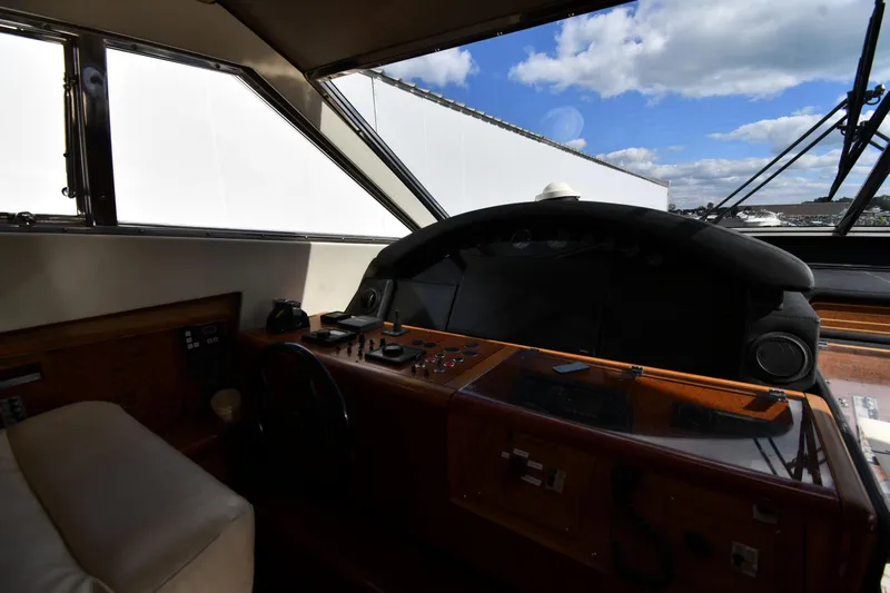 Surfin The Net Yacht Photos Pics Helm of 2001 Ferretti Yachts 72 with wooden dashboard and panoramic windows.