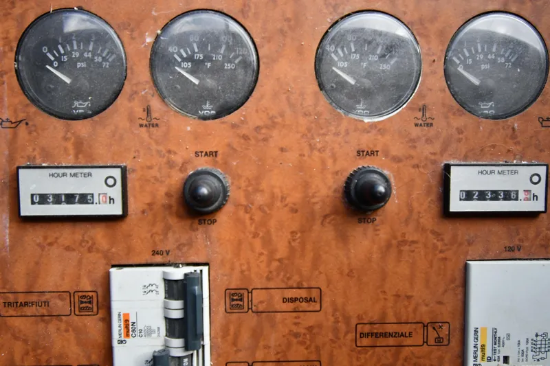 Surfin The Net Yacht Photos Pics Control panel of a 2001 Ferretti Yachts 72, featuring gauges and hour meters.