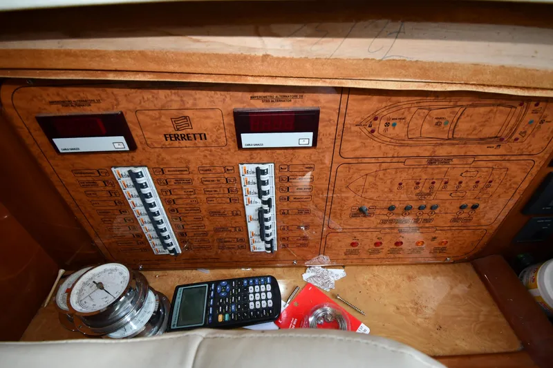 Surfin The Net Yacht Photos Pics Control panel of a 2001 Ferretti Yachts 72, featuring switches and navigation tools.