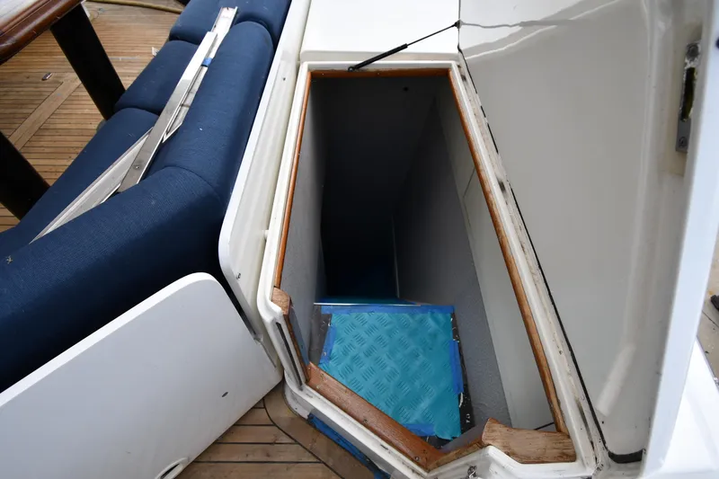 Surfin The Net Yacht Photos Pics Open storage compartment on 2001 Ferretti Yachts 72, featuring blue cushioned seating.