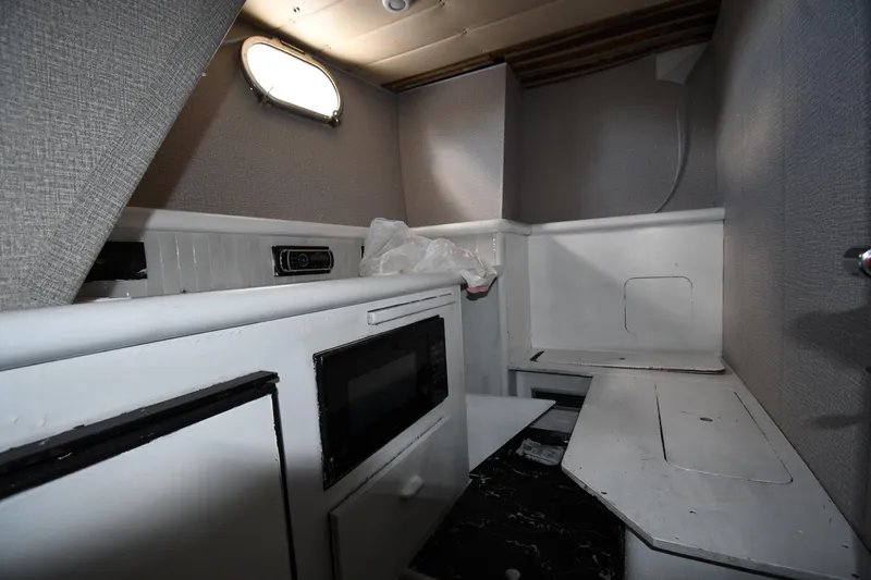 Surfin The Net Yacht Photos Pics Interior of 2001 Ferretti Yachts 72, featuring compact kitchen area with microwave.