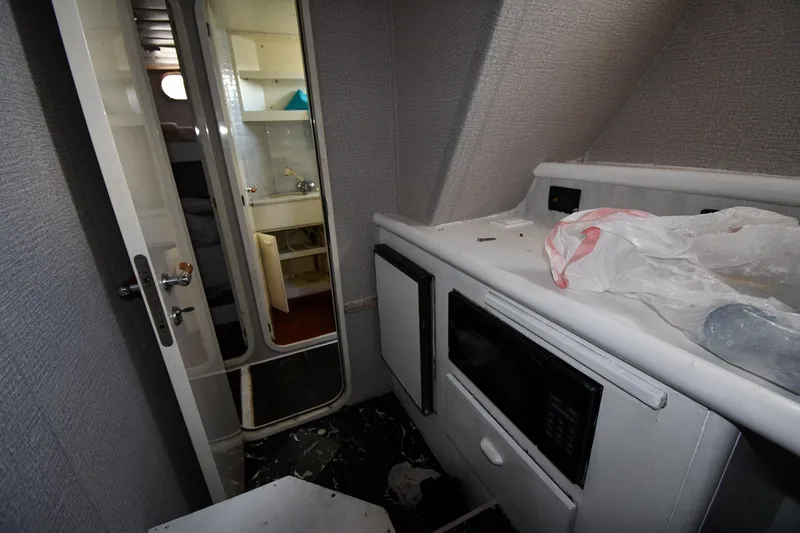 Surfin The Net Yacht Photos Pics Interior of 2001 Ferretti Yachts 72, featuring a compact kitchen area with appliances.