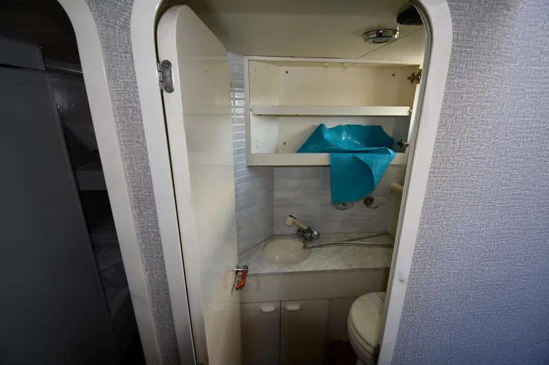 Surfin The Net Yacht Photos Pics Compact bathroom in a 2001 Ferretti Yachts 72, featuring a sink and storage shelves.