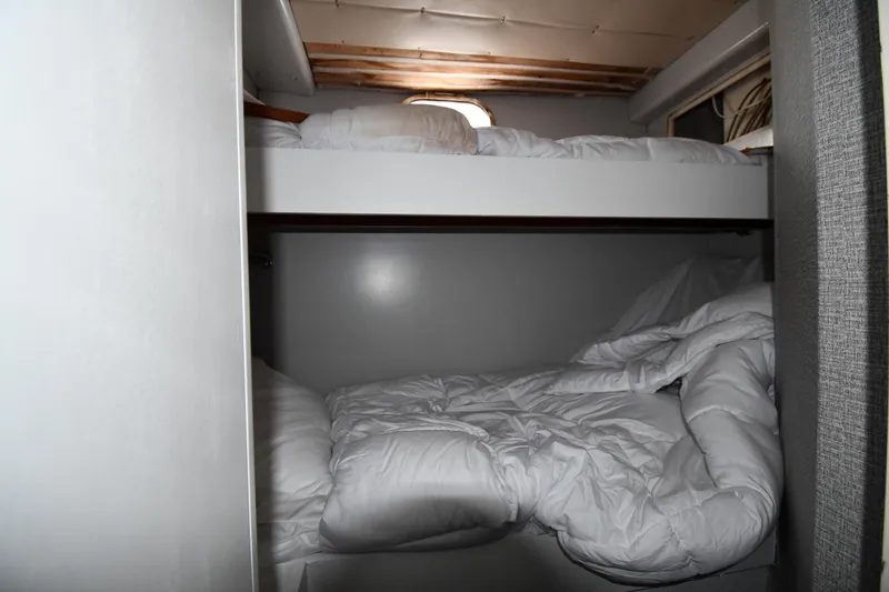Surfin The Net Yacht Photos Pics Bunk beds in 2001 Ferretti Yachts 72 cabin, featuring cozy white bedding.