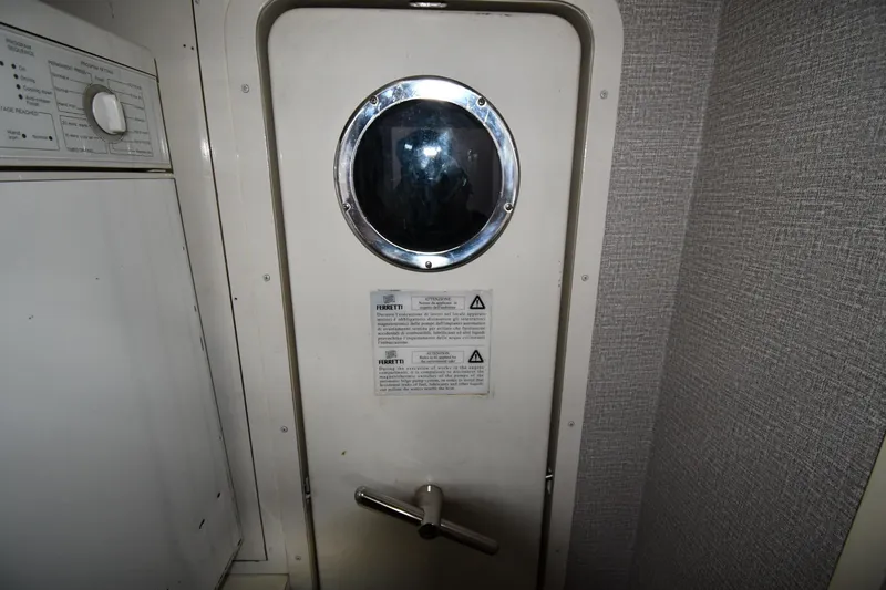 Surfin The Net Yacht Photos Pics Interior of 2001 Ferretti Yachts 72, featuring a porthole and control panel.