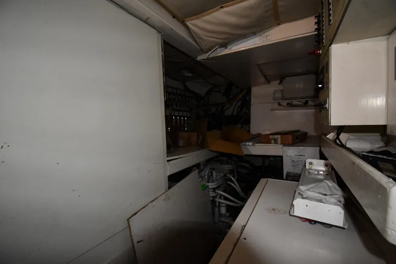 Surfin The Net Yacht Photos Pics Engine room of a 2001 Ferretti Yachts 72, showcasing mechanical components and storage.