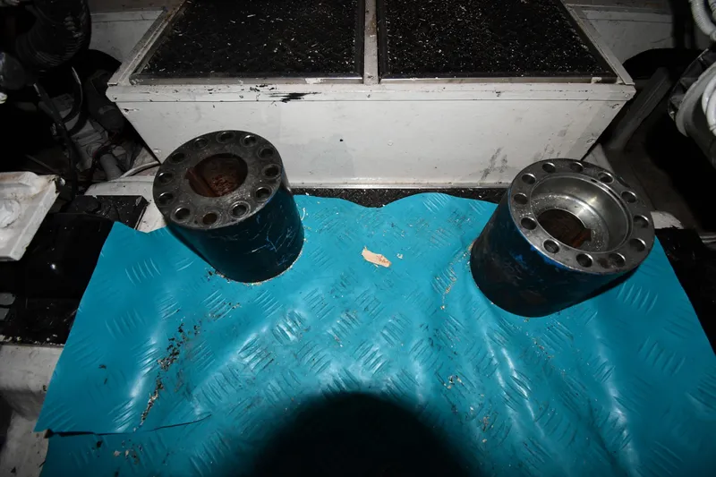 Surfin The Net Yacht Photos Pics Engine room components on a 2001 Ferretti Yachts 72, featuring metal cylinders on a blue mat.