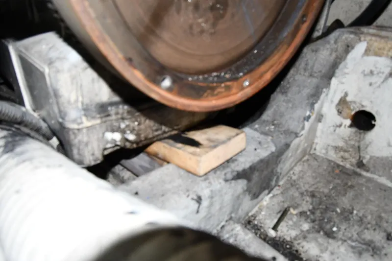 Surfin The Net Yacht Photos Pics Engine compartment of a 2001 Ferretti Yachts 72, showing mechanical components and a wooden block.