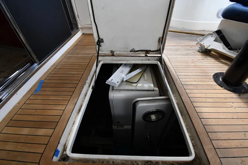 Surfin The Net Yacht Photos Pics Open hatch on 2001 Ferretti Yachts 72, revealing interior storage space.