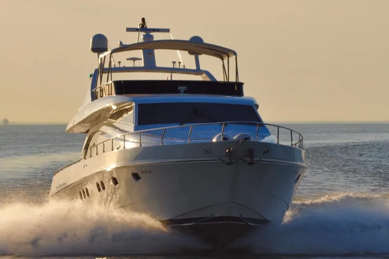 Surfin The Net Yacht Photos Pics Luxurious 2001 Ferretti Yachts 72 cruising on open water at sunset.