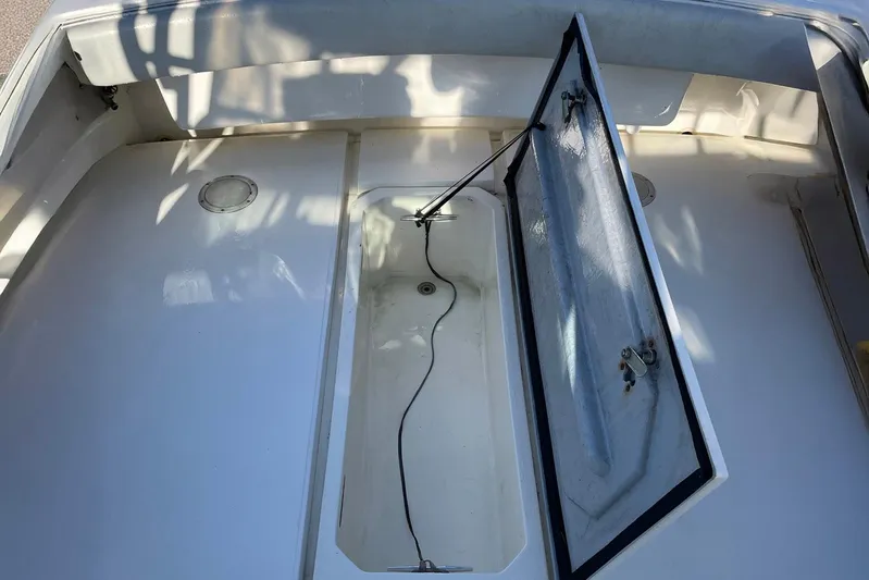 Low Bid Yacht Photos Pics Open hatch on 2007 Albemarle 280 Express Fisherman boat deck, showing storage compartment.