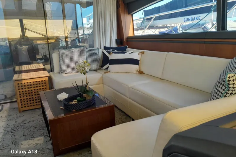 Gio Mare Yacht Photos Pics Luxurious interior of 2011 Princess V62 yacht with elegant white seating and nautical decor.