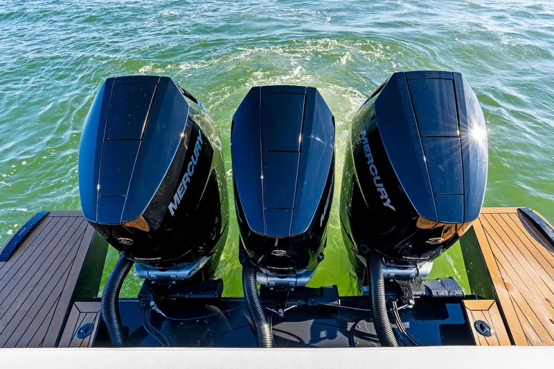  Yacht Photos Pics Triple Mercury outboard engines on 2025 XO Boats EXPLR 44, cruising in green waters.