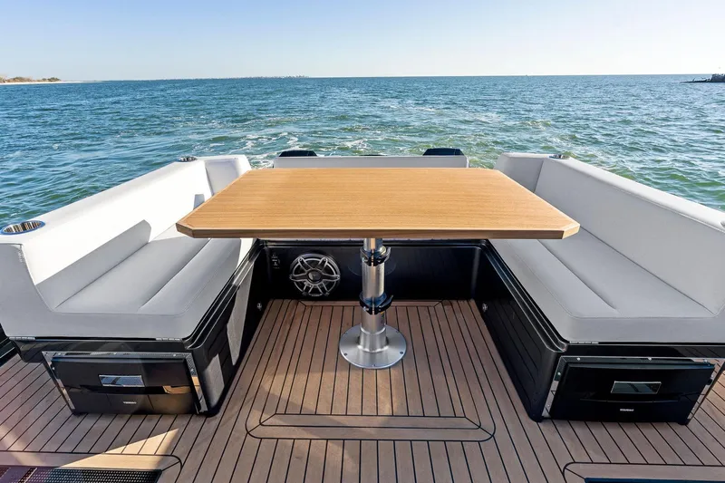  Yacht Photos Pics 2025 XO Boats EXPLR 44 deck with seating and table, overlooking the ocean.