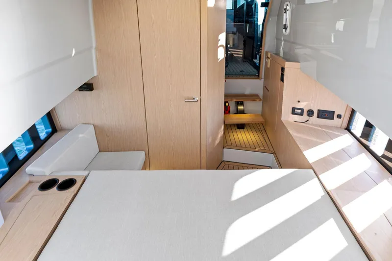  Yacht Photos Pics Modern interior of 2025 XO Boats EXPLR 44, featuring sleek wood finishes and ample natural light.