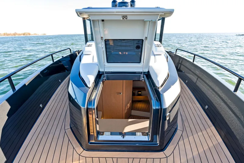  Yacht Photos Pics 2025 XO Boats EXPLR 44 deck view with open cabin entrance on the water.