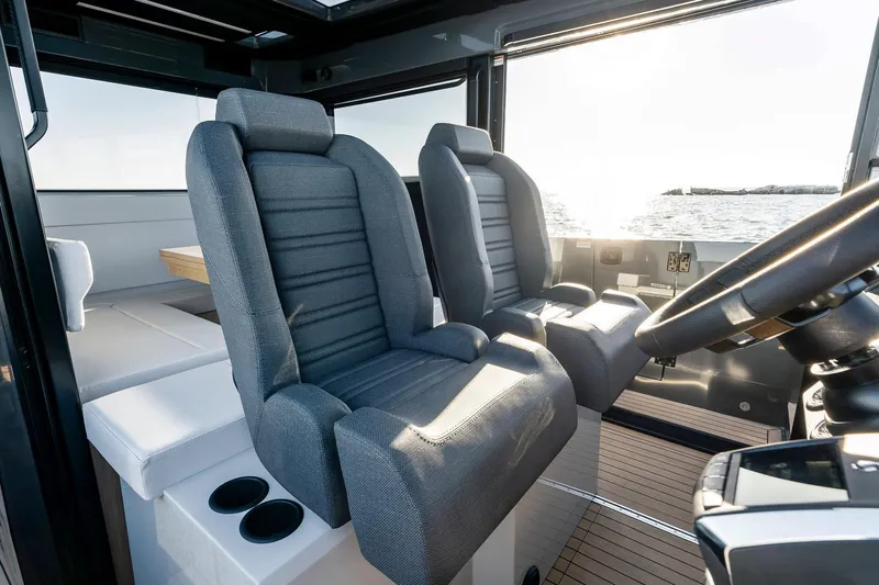  Yacht Photos Pics Interior of 2025 XO Boats EXPLR 44, featuring modern seating and steering wheel.