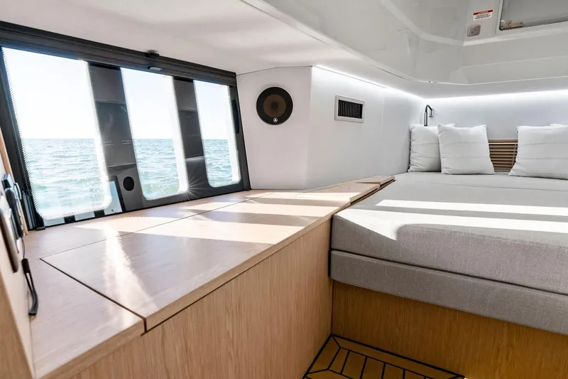  Yacht Photos Pics 2025 XO Boats EXPLR 44 cabin interior with ocean view, modern design, and comfortable bedding.