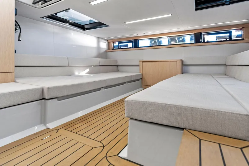  Yacht Photos Pics Modern interior of 2025 XO Boats EXPLR 44 with sleek seating and wooden flooring.