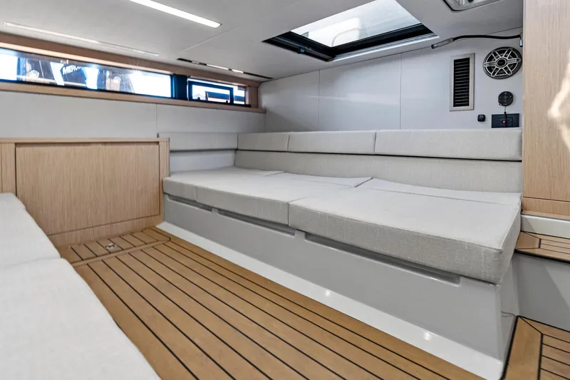  Yacht Photos Pics Modern interior of 2025 XO Boats EXPLR 44 with sleek seating and wood flooring.