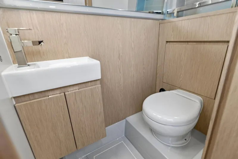  Yacht Photos Pics Modern bathroom in 2025 XO Boats EXPLR 44, featuring sleek sink and toilet design.