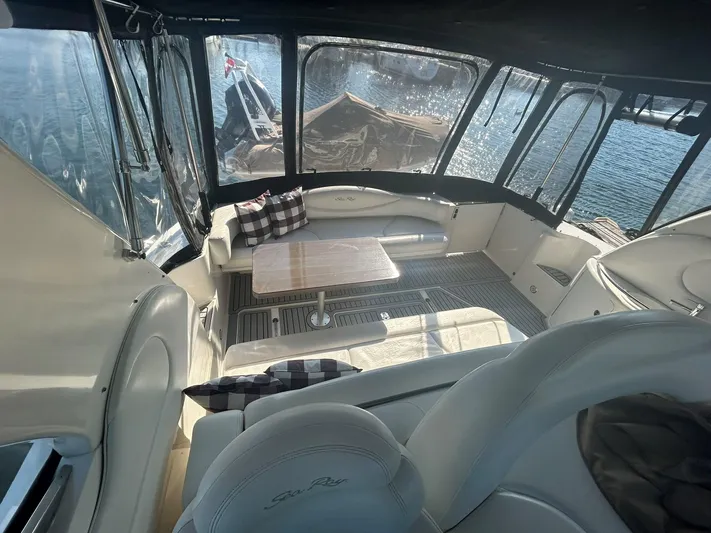  Yacht Photos Pics Interior of 2001 Sea Ray 410 Express Cruiser with seating and table, overlooking water.