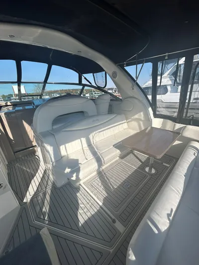  Yacht Photos Pics 2001 Sea Ray 410 Express Cruiser interior with white seating and wooden table.