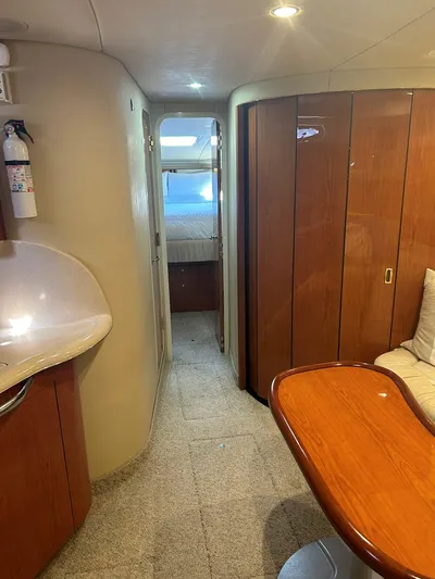  Yacht Photos Pics Interior of 2001 Sea Ray 410 Express Cruiser with wood paneling and cozy seating area.